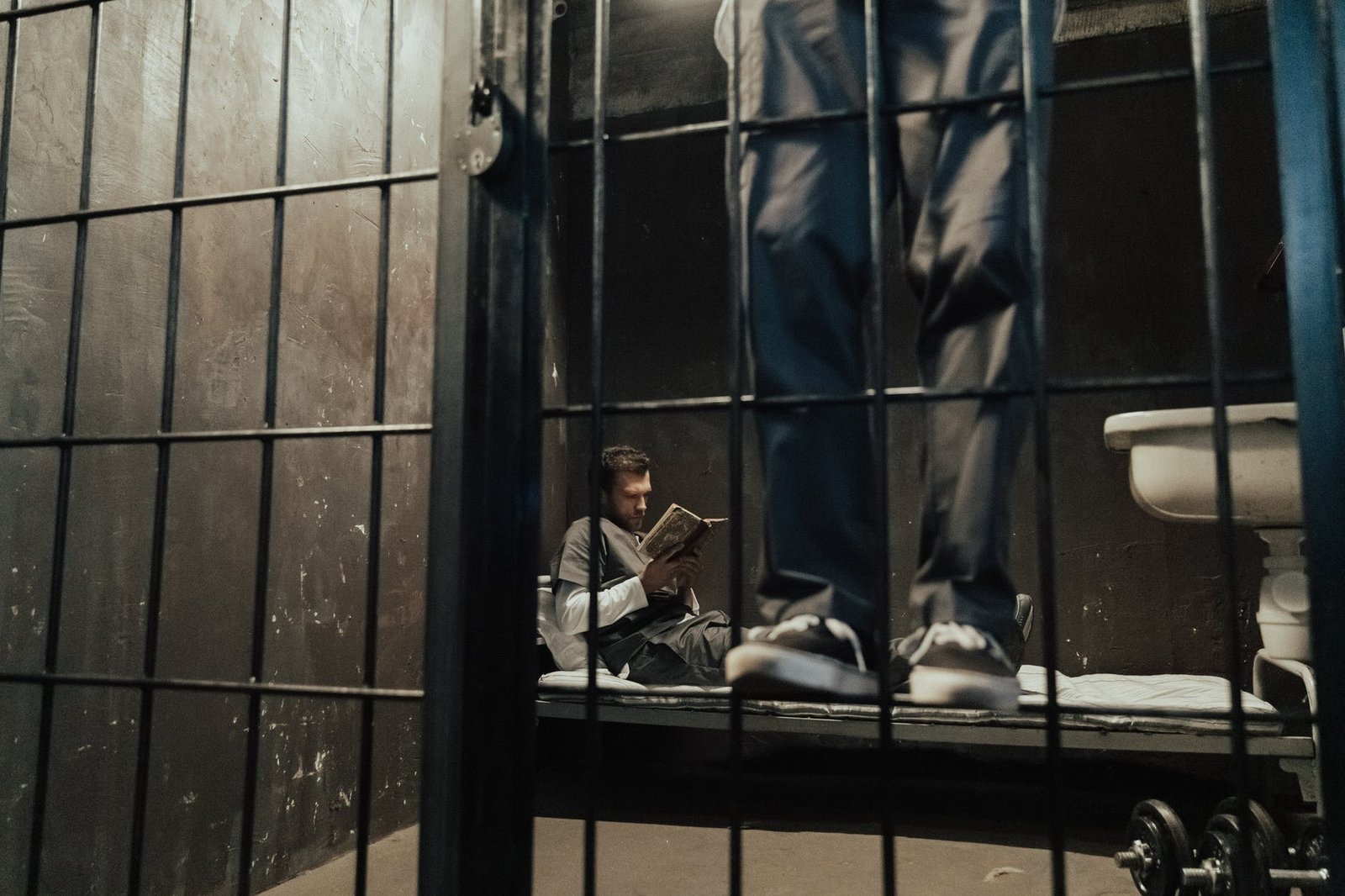 a man reading a book while in bed